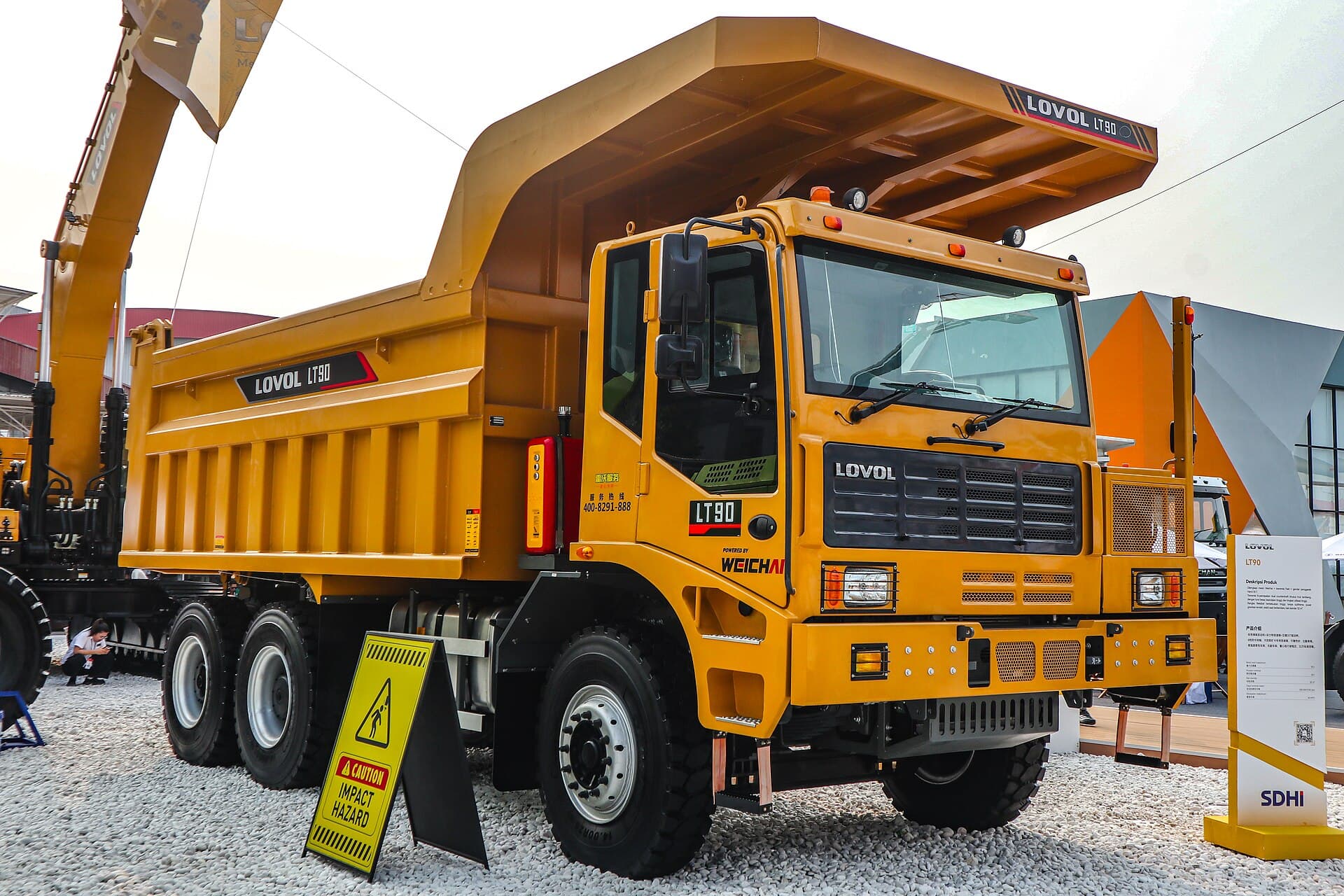 Rigid mining dump truck being loaded on a pit bench