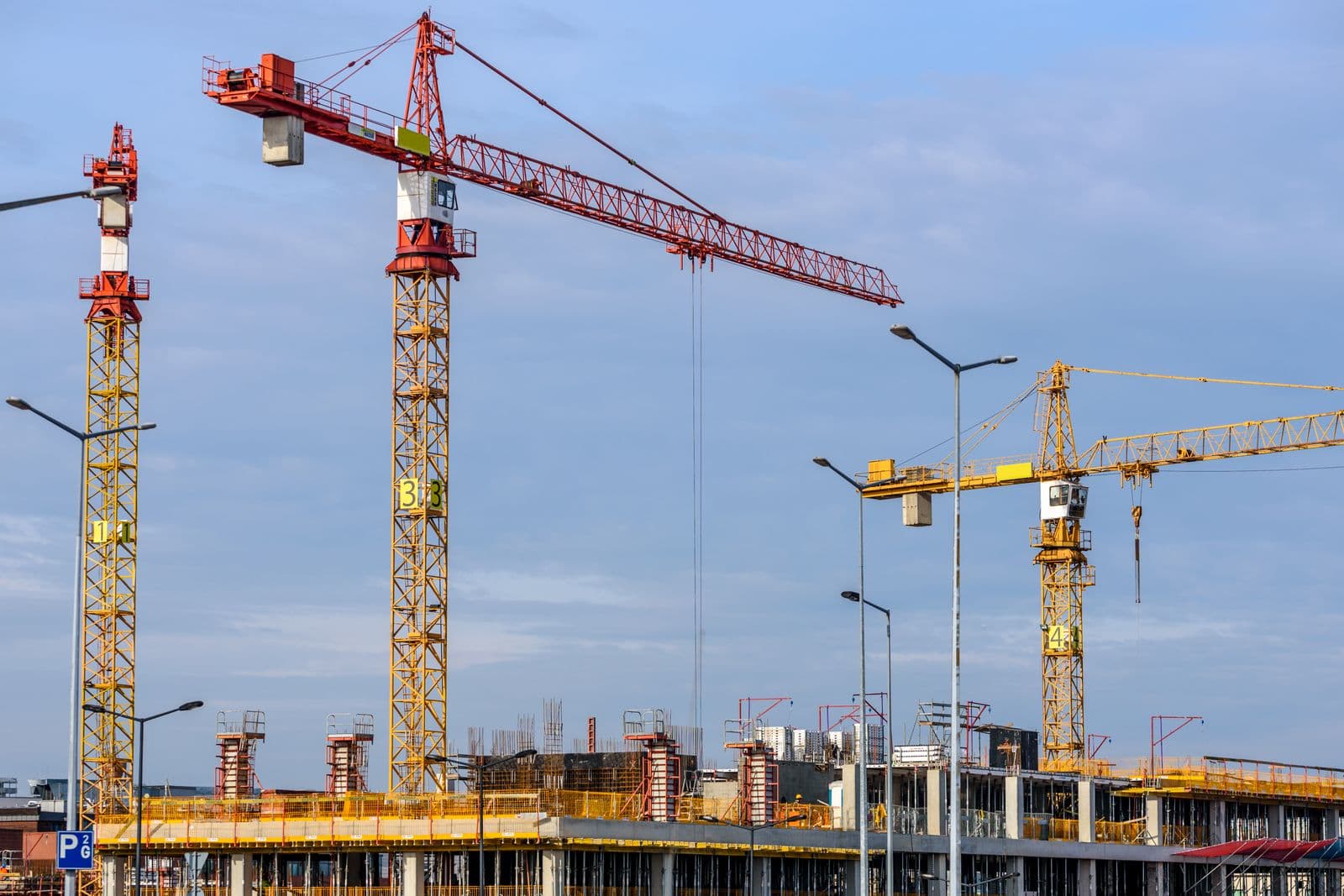 Tower cranes on a multi-storey construction site